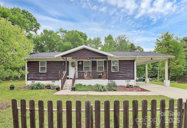 8301 Washington Blvd, Charlotte, NC 28262 - manufactured / mobile home with a front yard, a porch, crawl space, a fenced front yard, and driveway