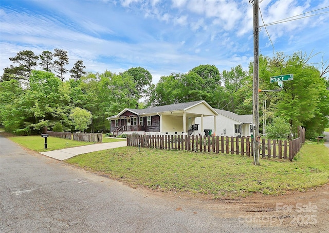 8301 Washington Blvd, Charlotte, NC 28262 - view of front of property featuring a carport, a front lawn, driveway, and a fenced front yard