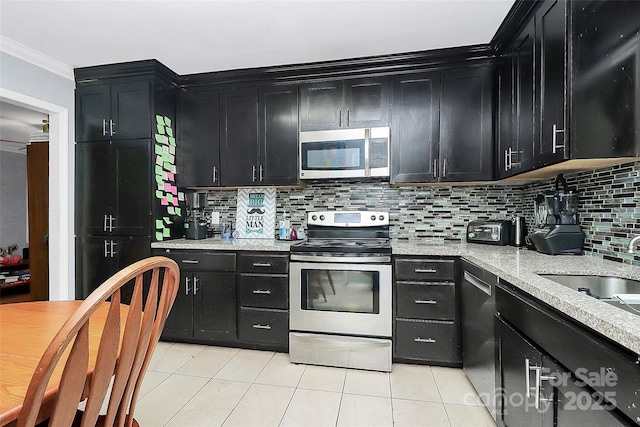8301 Washington Blvd, Charlotte, NC 28262 - kitchen with light tile patterned floors, dark cabinetry, and appliances with stainless steel finishes