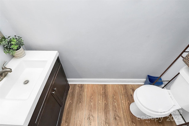 8301 Washington Blvd, Charlotte, NC 28262 - half bath featuring vanity, baseboards, toilet, and wood finished floors