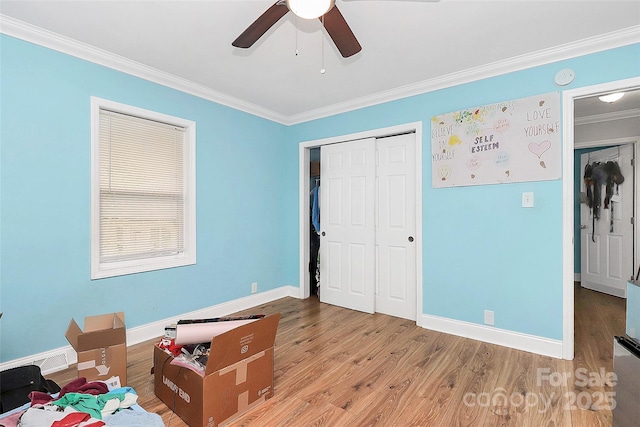8301 Washington Blvd, Charlotte, NC 28262 - unfurnished bedroom featuring crown molding, a closet, baseboards, and wood finished floors