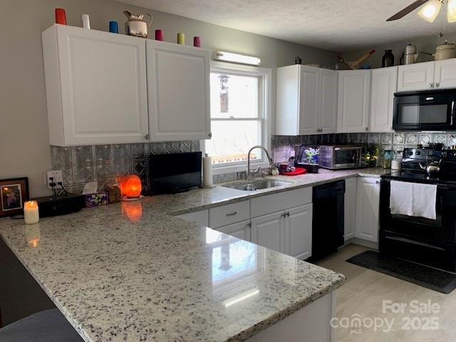 1474 Holiday Drive 14 & 15, Hendersonville, NC 28739 - kitchen with black appliances, a sink, a peninsula, decorative backsplash, and white cabinetry