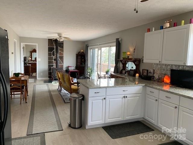 1474 Holiday Drive 14 & 15, Hendersonville, NC 28739 - kitchen with ceiling fan, a peninsula, light wood-style flooring, white cabinetry, and a textured ceiling