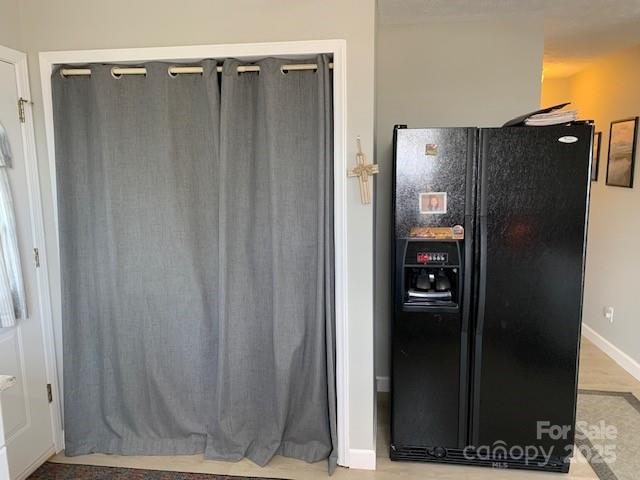 1474 Holiday Drive 14 & 15, Hendersonville, NC 28739 - kitchen featuring black fridge with ice dispenser and baseboards
