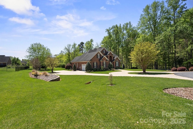 view of yard featuring curved driveway and a garage