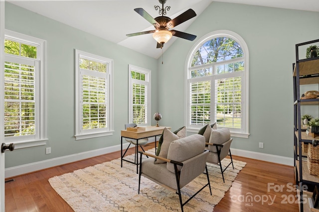 office area featuring ceiling fan, lofted ceiling, wood finished floors, and visible vents