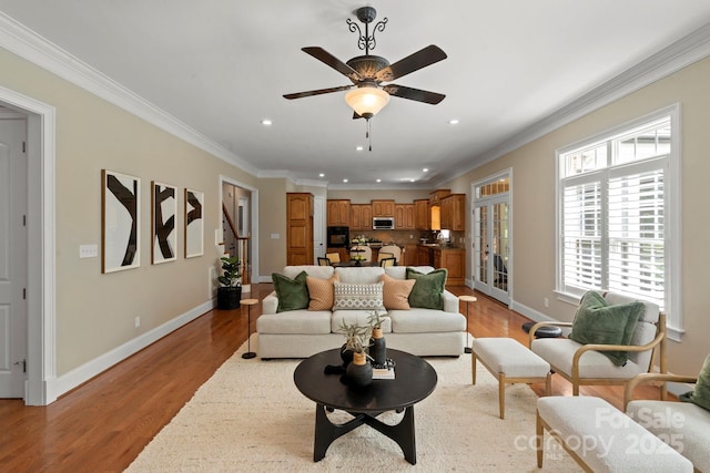 living room with baseboards, light wood-style floors, and recessed lighting