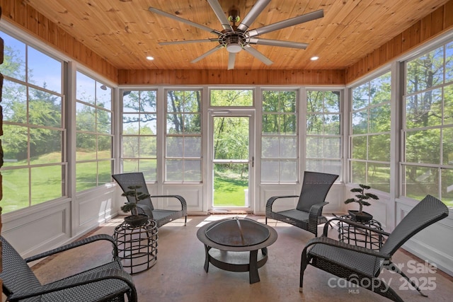 sunroom featuring ceiling fan and an outdoor fire pit