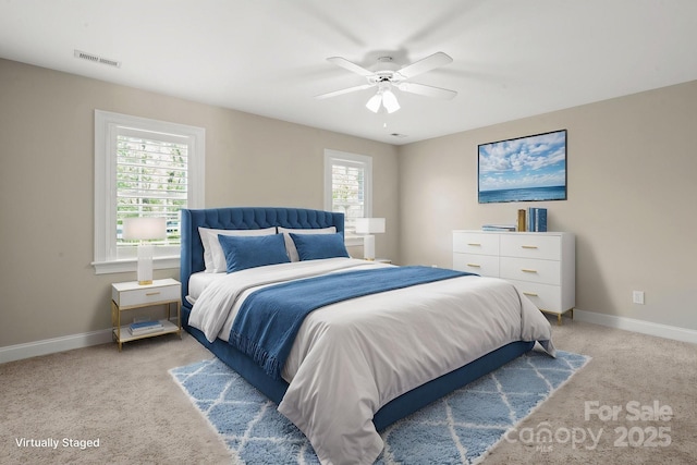 bedroom featuring visible vents, a ceiling fan, baseboards, and light carpet
