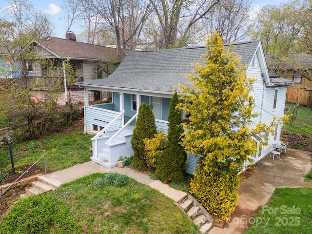 67 Montana Ave, Asheville, NC 28806 - view of front facade with fence, a front yard, roof with shingles, and a chimney