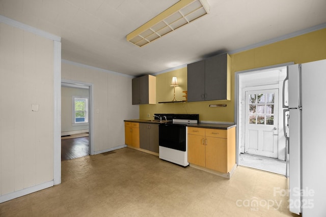 67 Montana Ave, Asheville, NC 28806 - kitchen featuring range with electric stovetop, a sink, dark countertops, freestanding refrigerator, and light floors