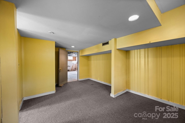 67 Montana Ave, Asheville, NC 28806 - below grade area with dark colored carpet, visible vents, and baseboards
