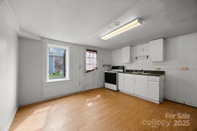 67 Montana Ave, Asheville, NC 28806 - kitchen featuring light wood-type flooring, a sink, dark countertops, and white electric stove