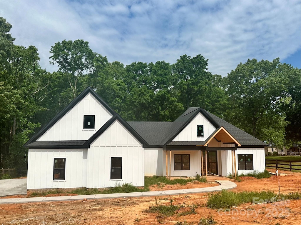 12069 Coyle Rd, Stanfield, NC 28163 - modern farmhouse style home with board and batten siding, a shingled roof, and fence