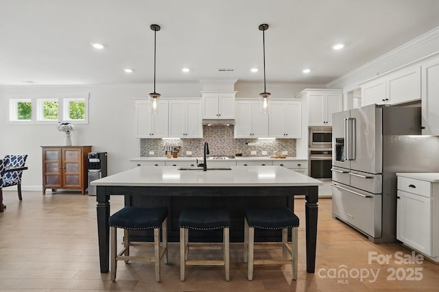 4120 Spring Cove Way, Belmont, NC 28012 - kitchen with stainless steel appliances, light countertops, and a kitchen bar