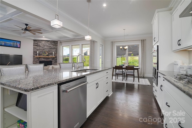 8313 Balcony Bridge Rd, Huntersville, NC 28078 - kitchen featuring appliances with stainless steel finishes, a sink, a fireplace, a center island with sink, and a chandelier