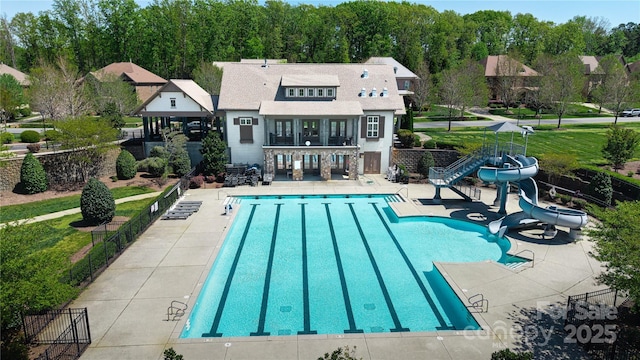 8313 Balcony Bridge Rd, Huntersville, NC 28078 - back of house featuring a patio, a community pool, a standing seam roof, and a balcony