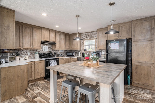 980 Lakeland Ave, Lincolnton, NC 28092 - kitchen with backsplash, dark wood-style floors, butcher block counters, under cabinet range hood, and black appliances