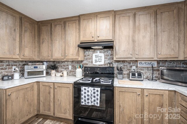 980 Lakeland Ave, Lincolnton, NC 28092 - kitchen with light countertops, under cabinet range hood, and black / electric stove