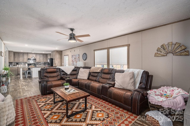 980 Lakeland Ave, Lincolnton, NC 28092 - living area featuring a textured ceiling, wood finished floors, and a ceiling fan