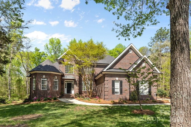 view of front of house featuring a front yard and brick siding