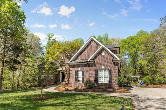view of front of property with a front yard and brick siding