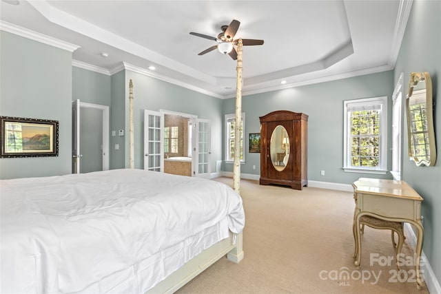 carpeted bedroom with crown molding, a tray ceiling, baseboards, and recessed lighting