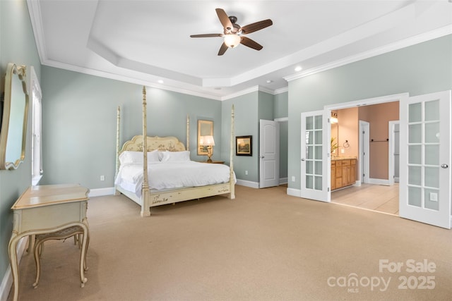unfurnished bedroom with baseboards, a raised ceiling, ornamental molding, carpet floors, and french doors