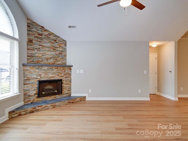 4754 Polo Gate Blvd, Charlotte, NC 28216 - unfurnished living room with high vaulted ceiling, wood finished floors, a stone fireplace, visible vents, and ceiling fan