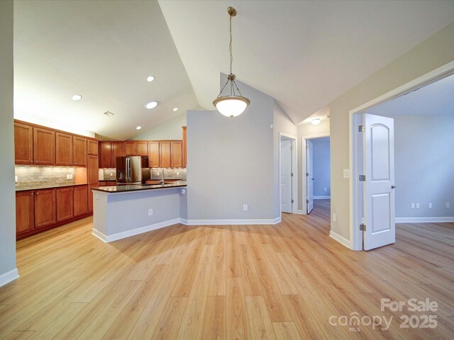 4754 Polo Gate Blvd, Charlotte, NC 28216 - kitchen featuring stainless steel fridge, a peninsula, hanging light fixtures, light wood-type flooring, and decorative backsplash