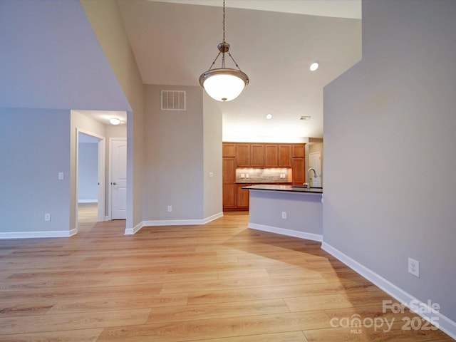 4754 Polo Gate Blvd, Charlotte, NC 28216 - interior space featuring a sink, baseboards, light wood finished floors, and visible vents