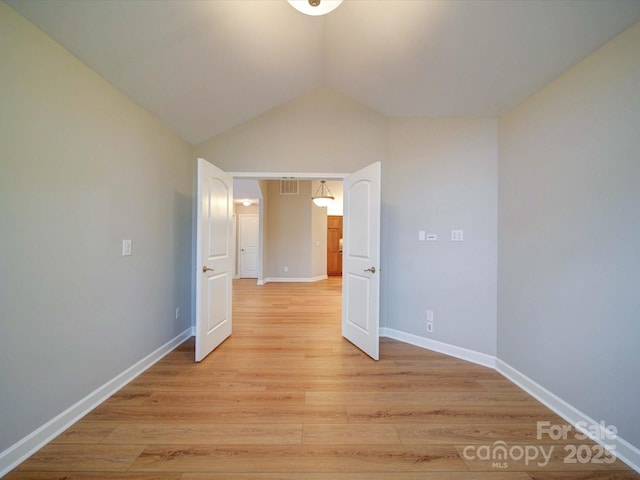 4754 Polo Gate Blvd, Charlotte, NC 28216 - spare room featuring baseboards, lofted ceiling, visible vents, and light wood-style floors