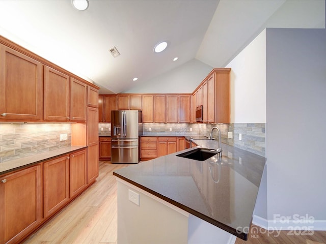 4754 Polo Gate Blvd, Charlotte, NC 28216 - kitchen with vaulted ceiling, a sink, light wood finished floors, visible vents, and appliances with stainless steel finishes