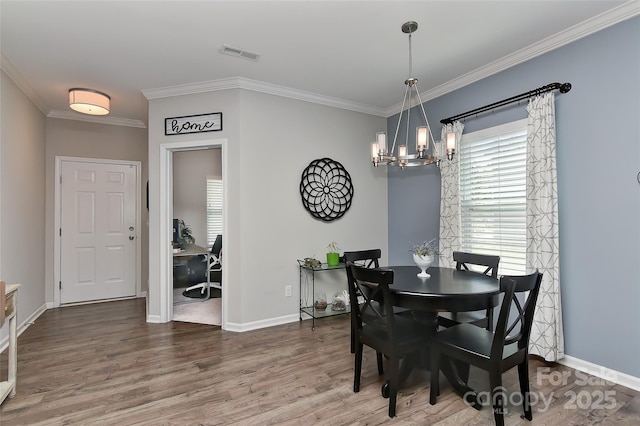 15035 Ockeechobee Ct, Mint Hill, NC 28227 - dining area featuring visible vents, wood finished floors, a notable chandelier, and crown molding