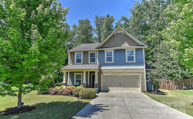 15035 Ockeechobee Ct, Mint Hill, NC 28227 - craftsman house featuring fence, concrete driveway, an attached garage, and a front lawn