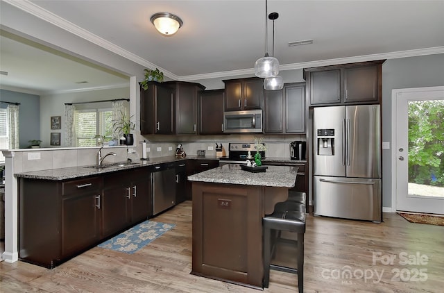 15035 Ockeechobee Ct, Mint Hill, NC 28227 - kitchen with a sink, light wood-style floors, tasteful backsplash, visible vents, and appliances with stainless steel finishes