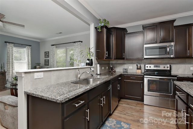 15035 Ockeechobee Ct, Mint Hill, NC 28227 - kitchen featuring dark brown cabinetry, a healthy amount of sunlight, appliances with stainless steel finishes, and a sink