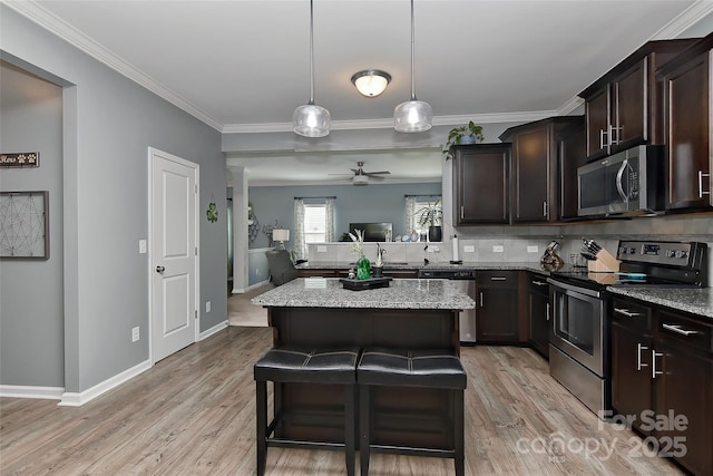 15035 Ockeechobee Ct, Mint Hill, NC 28227 - kitchen with crown molding, light stone counters, stainless steel appliances, and a kitchen island