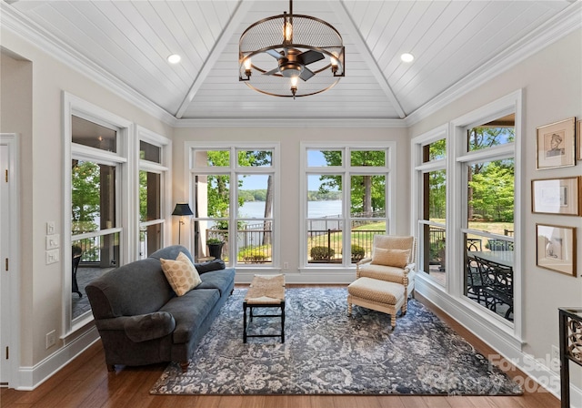 sunroom featuring a water view, a chandelier, and plenty of natural light