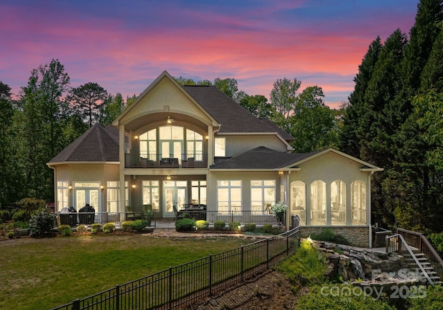 1328 Astoria Pkwy, Sherrills Ford, NC 28609 - back of property at dusk with stucco siding, french doors, a balcony, and roof with shingles