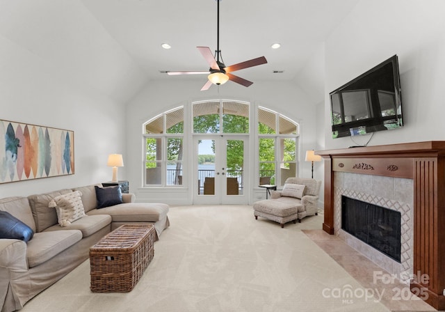 1328 Astoria Pkwy, Sherrills Ford, NC 28609 - living room featuring a tile fireplace, carpet floors, ceiling fan, french doors, and high vaulted ceiling