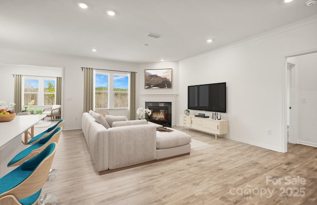 13756 Roderick Dr Unit 176, Huntersville, NC 28078 - living area featuring light wood finished floors, a glass covered fireplace, visible vents, and recessed lighting