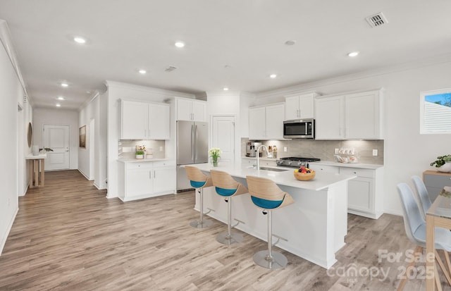 13756 Roderick Dr Unit 176, Huntersville, NC 28078 - kitchen featuring visible vents, a sink, light countertops, appliances with stainless steel finishes, and decorative backsplash