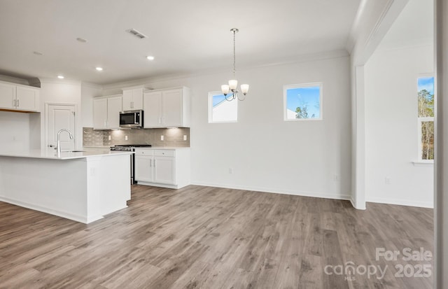 13756 Roderick Dr Unit 176, Huntersville, NC 28078 - kitchen with ornamental molding, light countertops, backsplash, visible vents, and appliances with stainless steel finishes