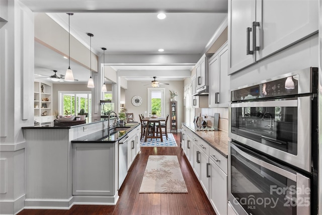 kitchen featuring decorative backsplash, ceiling fan, dark wood-style flooring, stainless steel appliances, and recessed lighting