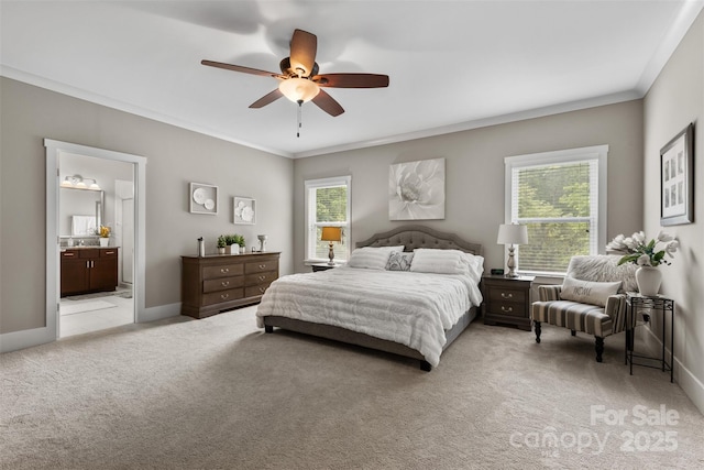 bedroom featuring baseboards, ornamental molding, connected bathroom, and light colored carpet