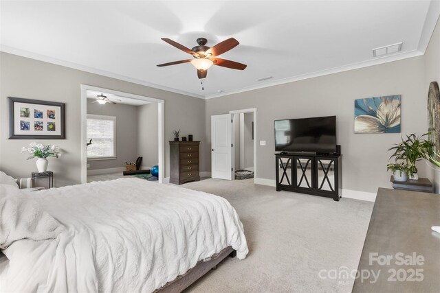 carpeted bedroom with crown molding, a ceiling fan, baseboards, and visible vents