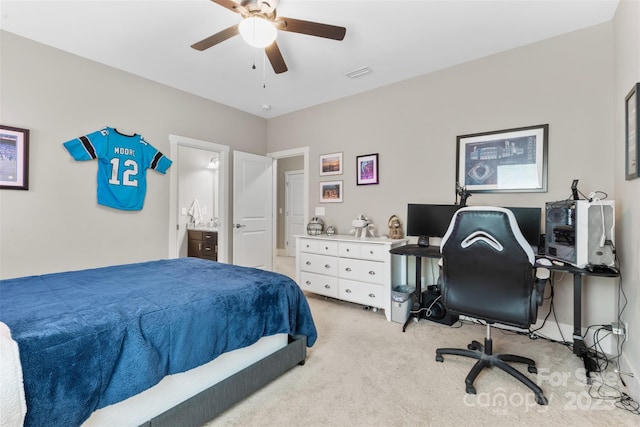 bedroom with visible vents, ceiling fan, ensuite bath, and light carpet
