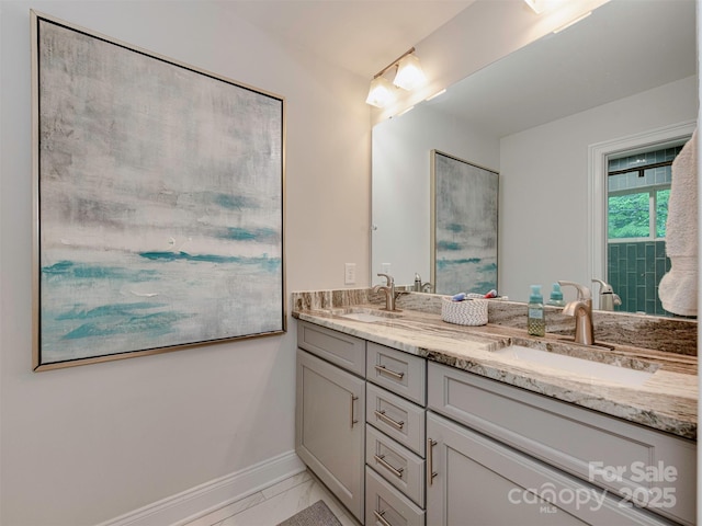 7048 Delta Lake Dr, Charlotte, NC 28215 - full bath featuring baseboards, marble finish floor, double vanity, and a sink