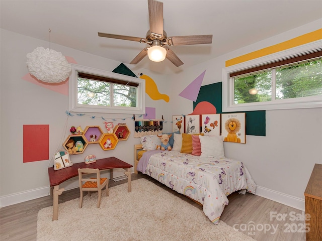7048 Delta Lake Dr, Charlotte, NC 28215 - bedroom with baseboards, ceiling fan, and wood finished floors